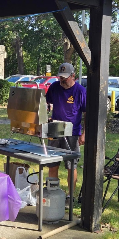 Joe McCullough cooked brats and hot dogs for the crowd